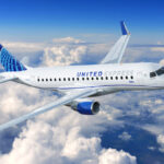 Embraer E175 aircraft with United Airlines livery flying above the clouds