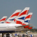 Tail fins of British Airways jet at Heathrow Airport.