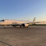 US debut of the Embraer E195-E2, aircraft parked on tarmac at sunset